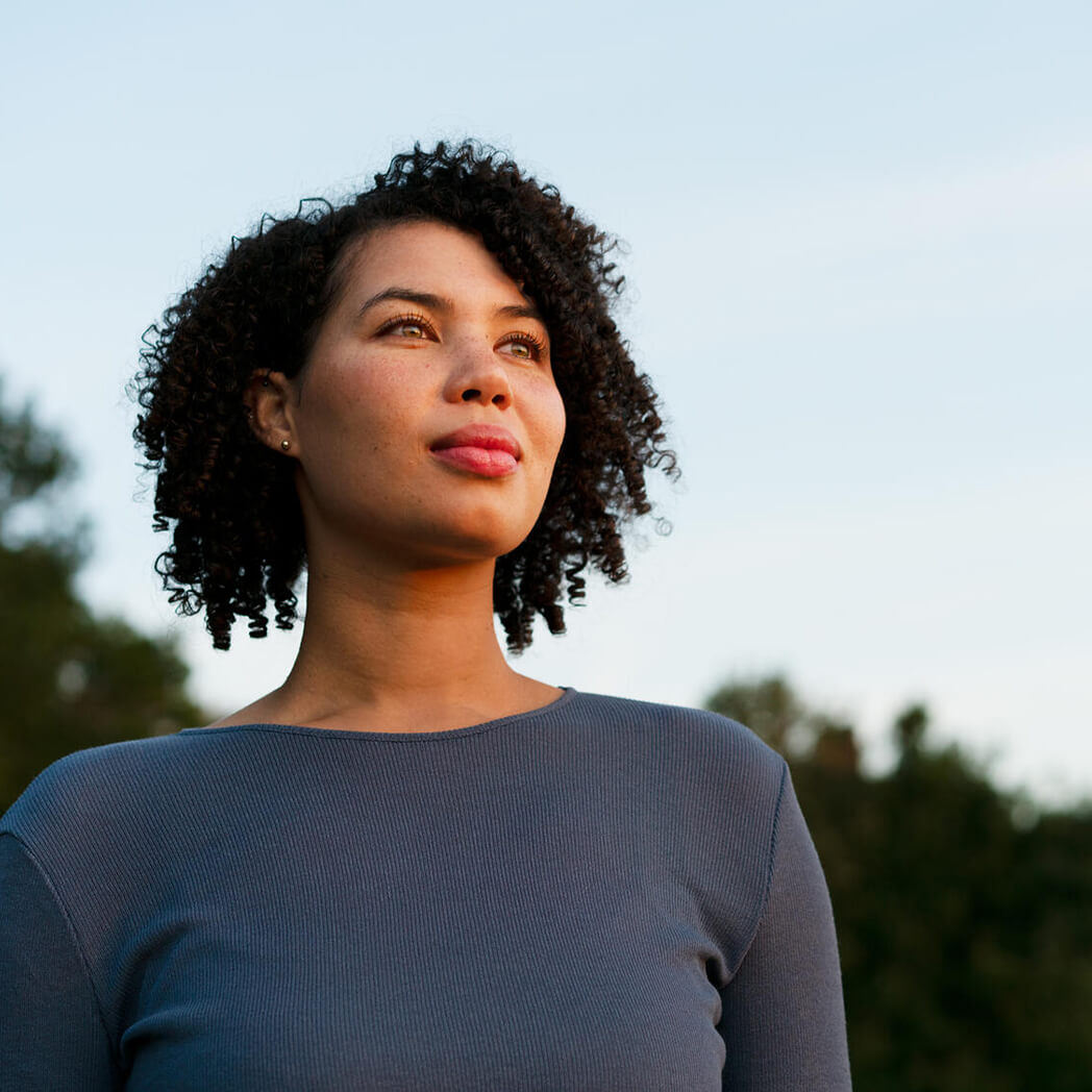 A woman looks in the distance.